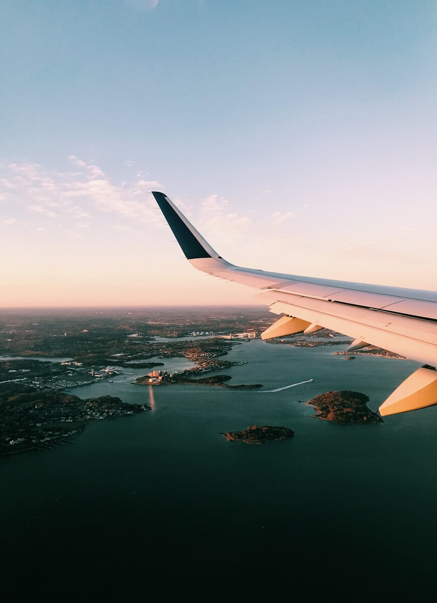 white airplane wing over the city during daytime